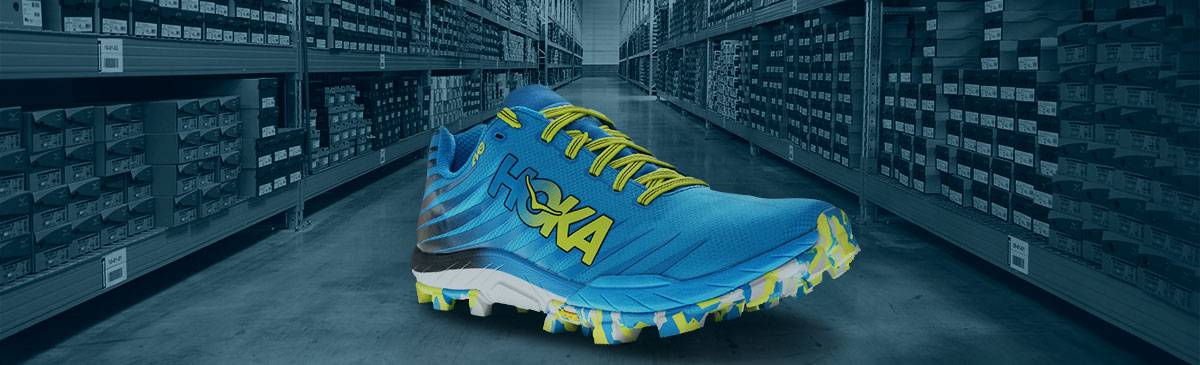 Scarpa Hoka su sfondo magazzino di i-Run